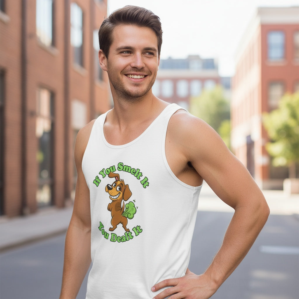 White unisex jersey tank top featuring a cartoon farting dog with green gas cloud and the phrase ‘If You Smelt It You Dealt It.’ Funny, cheeky men’s tank by Cheeky Tee Co.