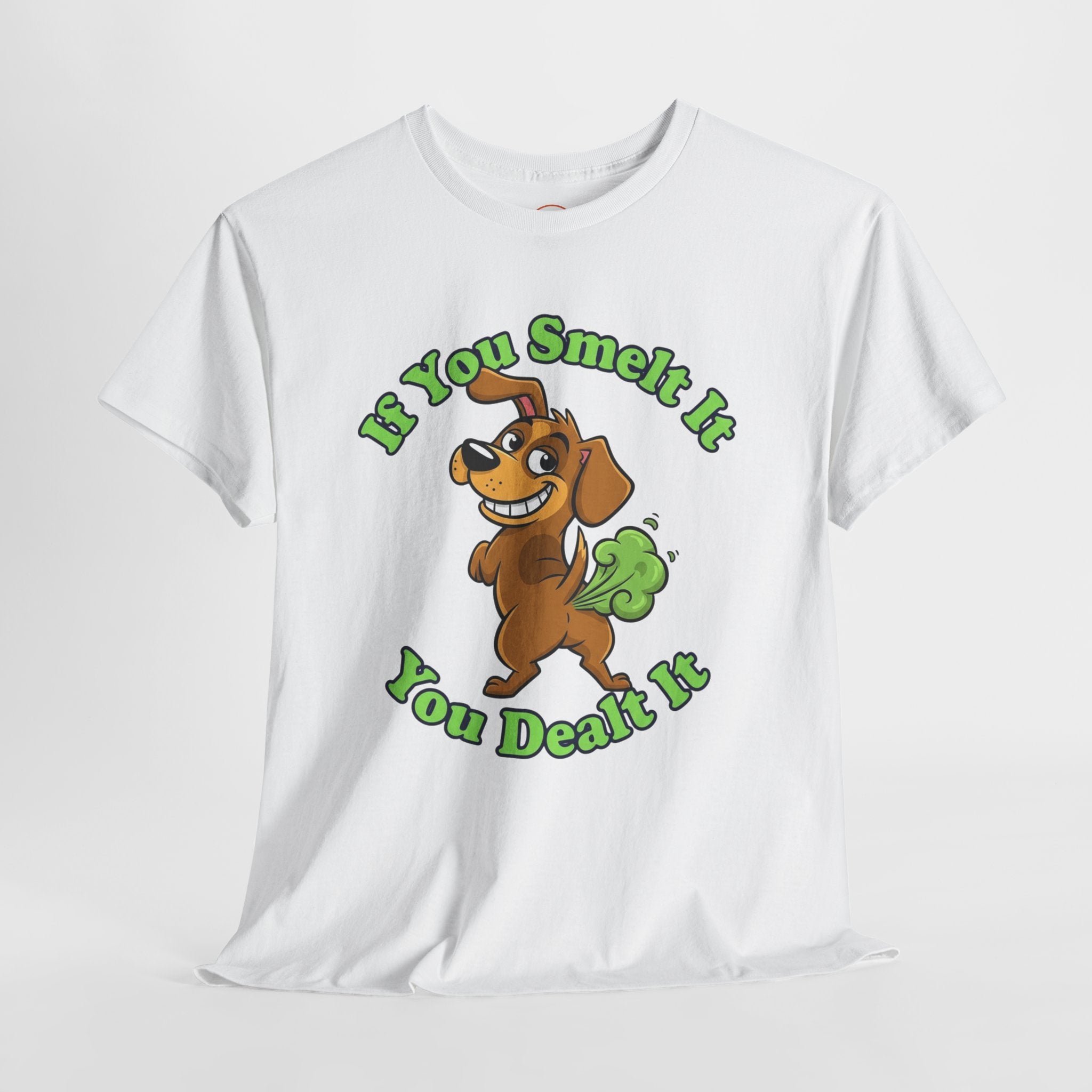 White unisex heavy cotton t-shirt with a cartoon farting dog and the phrase ‘If You Smelt It You Dealt It’ in bold green text. Funny, cheeky gift shirt by Cheeky Tee Co.