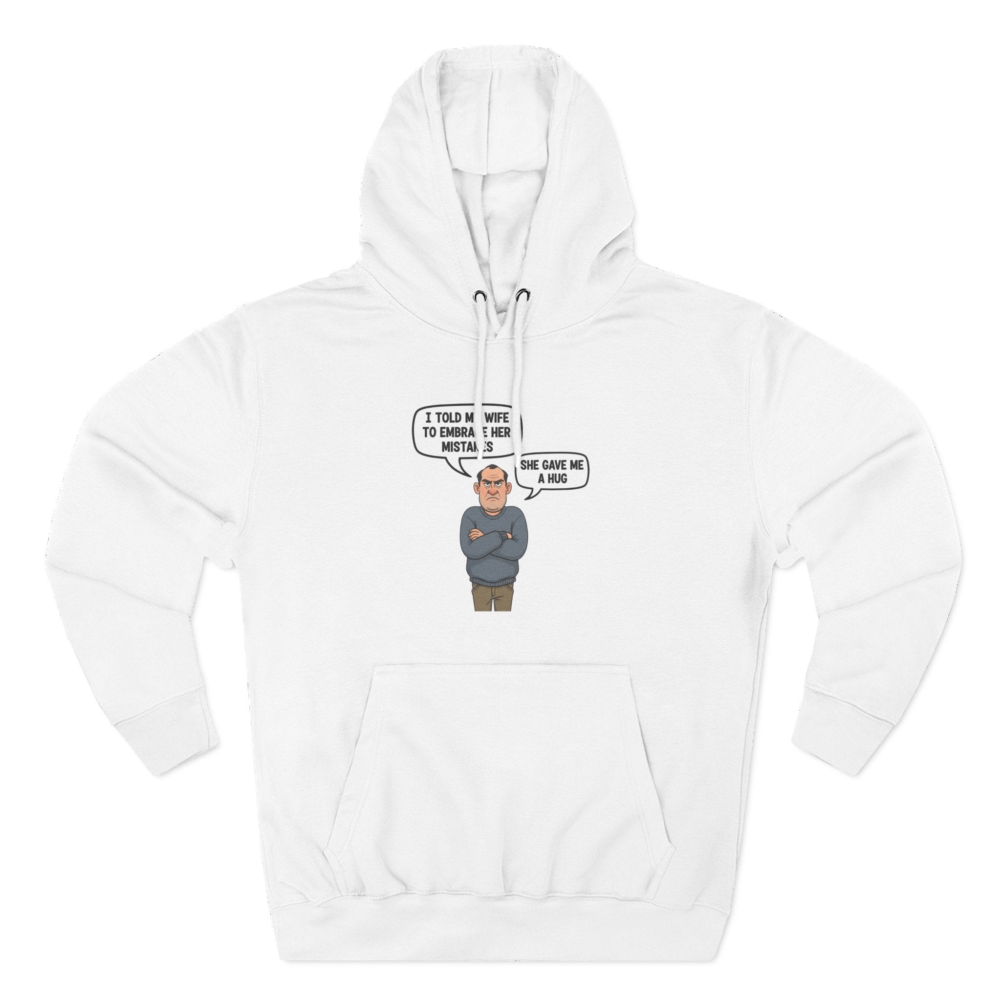 White fleece hoodie featuring a cartoon grumpy husband with the quote ‘I told my wife to embrace her mistakes. She gave me a hug.’ Funny, cheeky gift for men by Cheeky Tees Co.